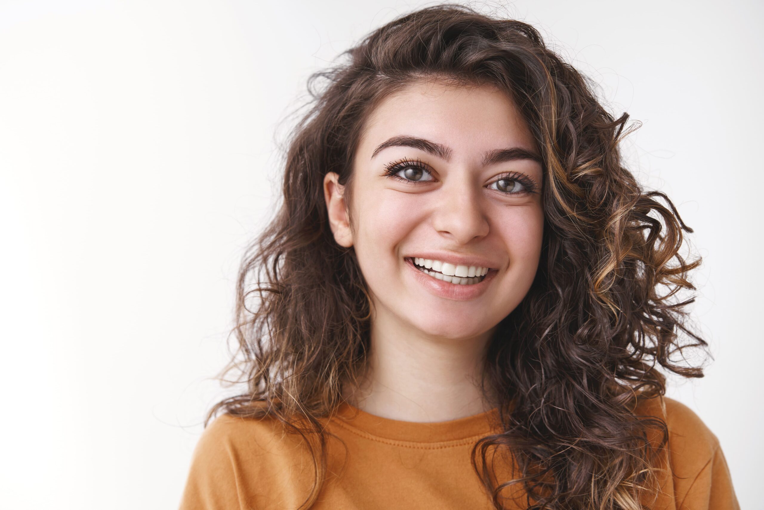 headshot-carefree-happy-lucky-young-curly-haired-positive-caucasian-woman-laughing-smiling-having-fun-enjoying-perfect-day-chatting-nice-friendly-talking-coworkers-standing-white-background (1)